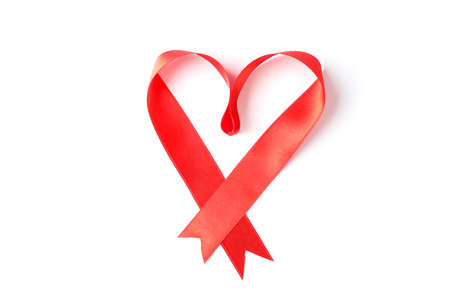 Red ribbon heart isolated on white backgroundの写真素材