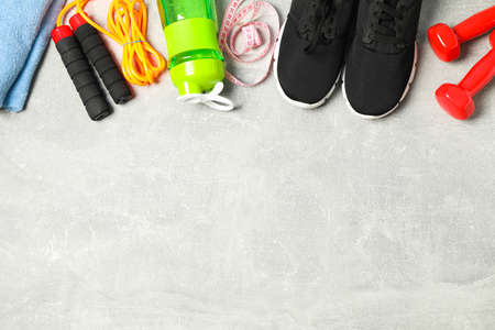 Flat lay composition with healthy lifestyle accessories on grey background