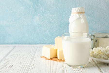 Different dairy products on white wooden table against blue background, copy spaceの写真素材