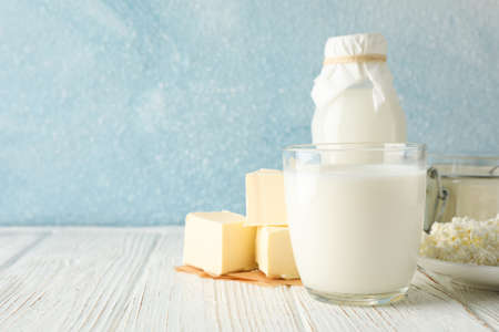 Different dairy products on white wooden table against blue background, copy spaceの写真素材