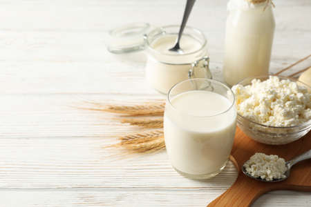 Spikelets of wheat, dairy products and board on white wood background, copy spaceの写真素材
