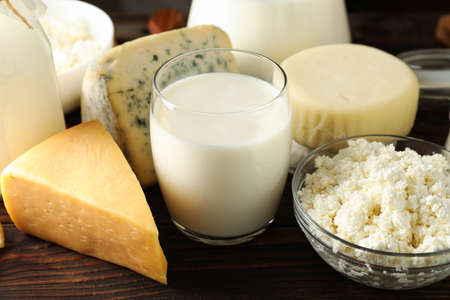 Different dairy products on wooden background, close up