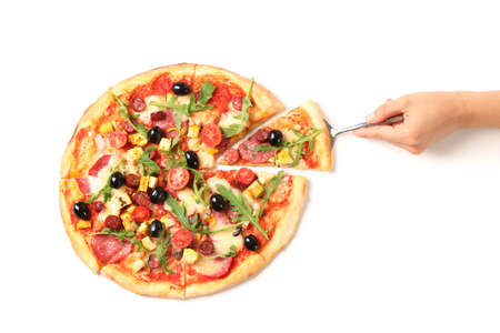 Female hand takes a piece of pizza, isolated on white backgroundの写真素材
