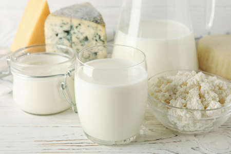 Different dairy products on white wooden background, close upの写真素材