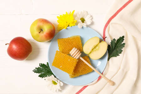 Honey, flowers and apples on white wooden background, copy spaceの写真素材
