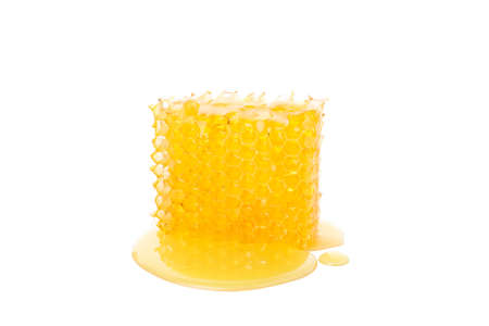 Piece of honeycomb isolated on white background, close up