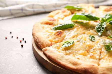 Cheese pizza with basil and spices on grey background, close upの写真素材