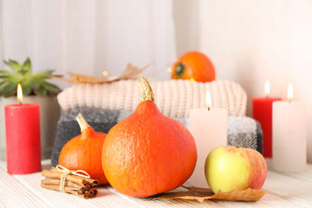 Pumpkins, clothes, leaves and candles on wooden background, copy spaceの写真素材