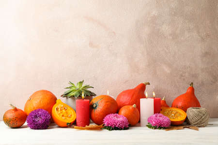Composition with pumpkins, flowers and candles on white wooden  background, copy spaceの写真素材