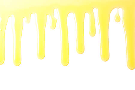 Flow of sweet honey isolated on white backgroundの写真素材