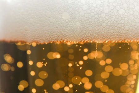 Beer and foam texture on whole background, close up