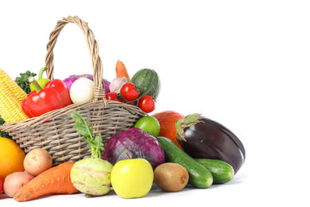 Wicker basket and different vegetables isolated on white backgroundの写真素材