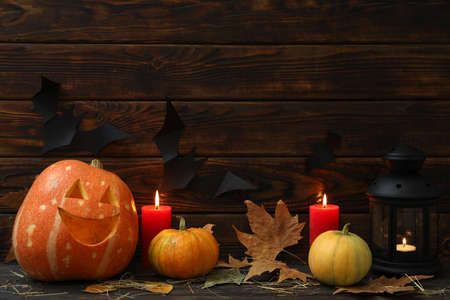 Halloween pumpkins and candles on dark wooden background, copy spaceの写真素材