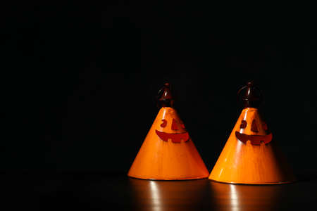 Orange halloween candlesticks on dark background, copy spaceの写真素材