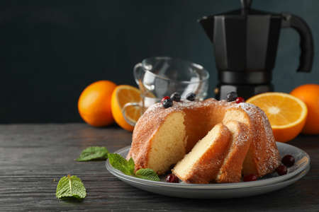 Cake with powdered sugar, berries and mint on wooden background, copy spaceの写真素材