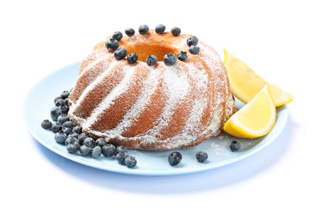 Cake with powdered sugar, blueberry and lemon isolated on white backgroundの写真素材