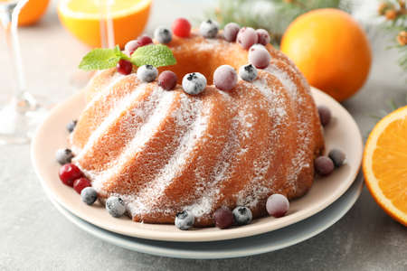 Cake with powder sugar and berries on grey table. Happy new year conceptの写真素材