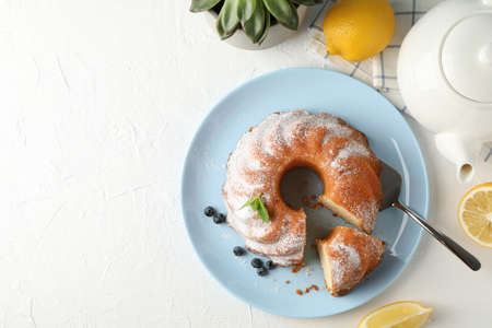 Cake with powdered sugar, blueberry and mint on white background, top viewの写真素材