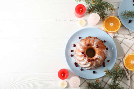 Cake with powder sugar and cranberry on white table. Christmas conceptの写真素材