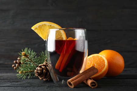 Glass of tasty mulled with orange on decorated background, space for textの写真素材