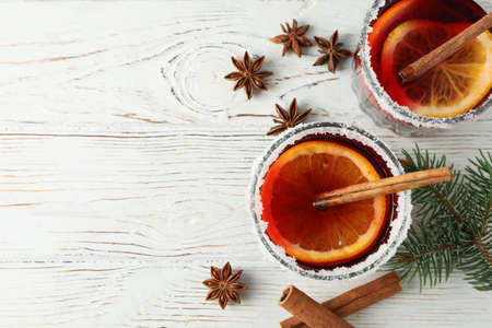 Glasses of tasty mulled wine on white wooden background, top viewの写真素材