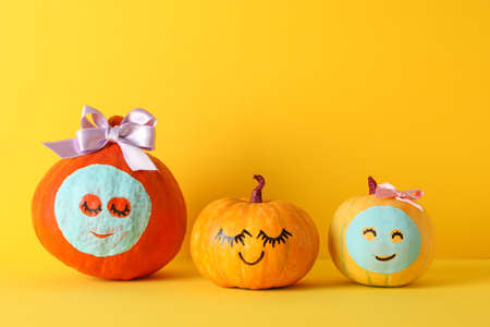 Funny pumpkins on yellow background. Body careの写真素材