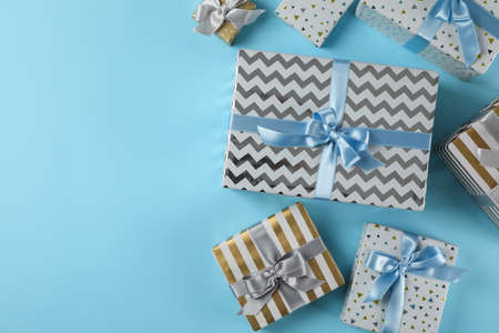 Different gift boxes on blue background, copy spaceの写真素材