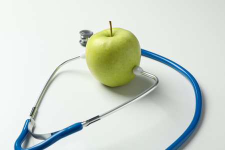 Stethoscope and apple on white background, close upの写真素材