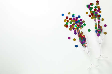Champagne glasses with glitter on white background, space for textの写真素材