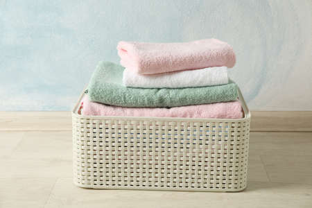 Basket with clean laundry on textured floor, space for textの写真素材