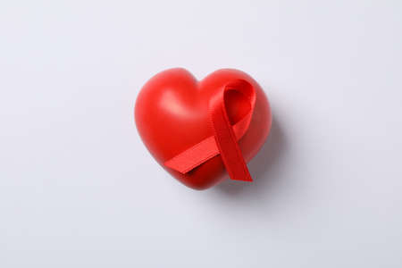 AIDS awareness red ribbon and heart on white background, space for textの写真素材
