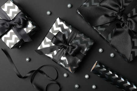 Gift boxes with bow on black background. Black Friday sale