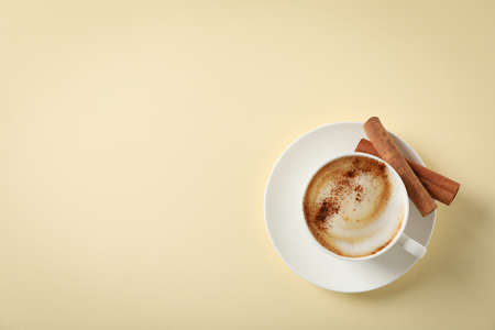 Cappuccino with cinnamon on beige background, space for textの写真素材