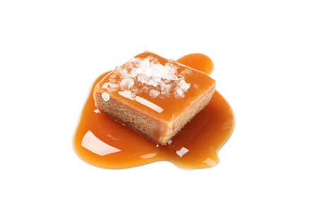 Salted caramel candy with sauce isolated on white backgroundの写真素材