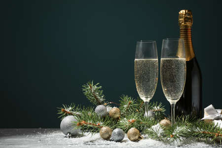 Champagne glasses and bottle on decorated background, space for textの写真素材