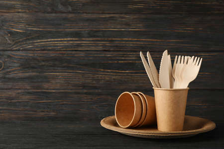 Eco - friendly tableware on wooden background, space for textの写真素材