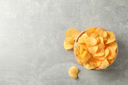 Potato chips. Beer snacks on grey background, space for text. Top view