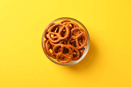 Crackers. Beer snacks on yellow background, space for text. Top viewの写真素材