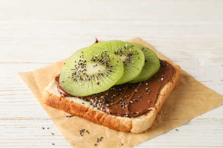 Toast with choco cream and kiwi on wooden background, close upの写真素材