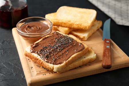 Concept of toasts with choco cream on wooden board, close upの写真素材