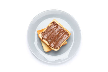 Toasts with chocolate cream on plate isolated on white backgroundの写真素材