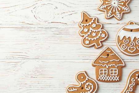 Tasty homemade Christmas cookies on white wooden background, space for text. Top view