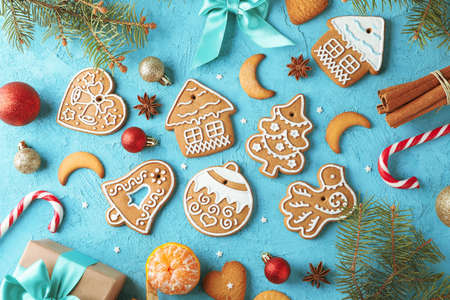 Flat lay composition with tasty homemade Christmas cookies on blue background. Top view