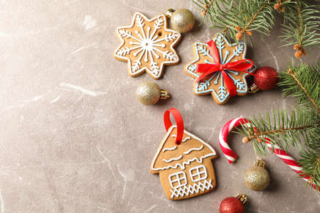 Homemade Christmas cookies, candies, toys on brown background, space for text. Top view