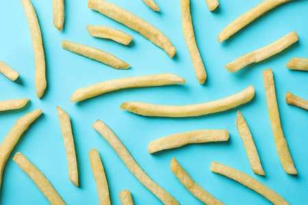 Flat lay with tasty french fries on blue background, top viewの写真素材