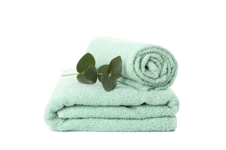 Folded towels and eucalyptus isolated on white backgroundの写真素材