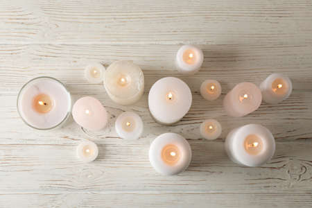 Different burning candles on wooden background, top viewの写真素材