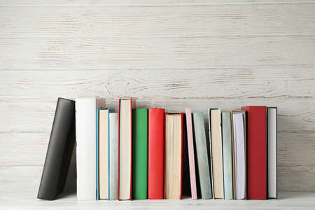 Books against rustic wooden background, space for textの写真素材