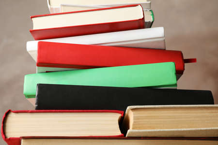 Stack of books against brown background, close upの写真素材