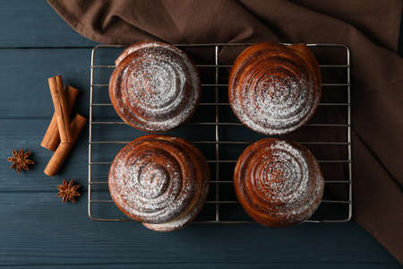 Cinnamon rolls, anise and towel on wooden background, top viewの写真素材